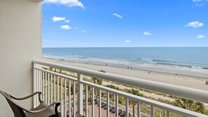 A balcony with a view of a beach and ocean. - Coastal Elegance OF King Suite Escape 4th Floor (Myrtle Beach)