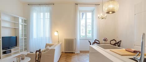 Family Apartment, 4 Bedrooms (Appartamento Reggenza) | Living area | 21-inch flat-screen TV with digital channels, TV