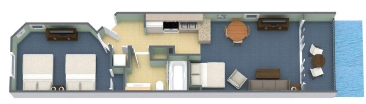 A floor plan of a hotel room with two beds, a kitchenette, a dining area, and a bathroom.