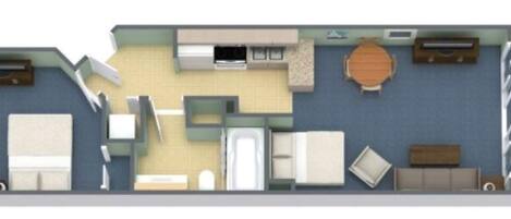 Un plan d’étage d’une chambre d’hôtel comprenant deux lits, un coin cuisine, un espace repas et une salle de bain.