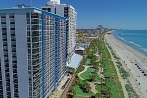 A high-rise hotel with multiple balconies, a beachside location, and a view of the ocean. - Attractive Oceanfront Condo at Bay View Resort (Myrtle Beach)