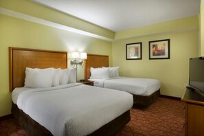 A hotel room with two beds, a television, and a small desk. - Attractive Oceanfront Condo at Bay View Resort (Myrtle Beach)