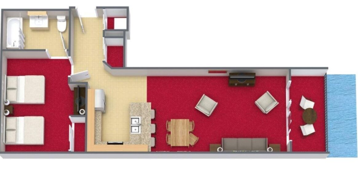 Une chambre d’hôtel comprenant une salle de bain, un espace de vie avec un canapé et une table à manger, et offrant une vue sur la mer.