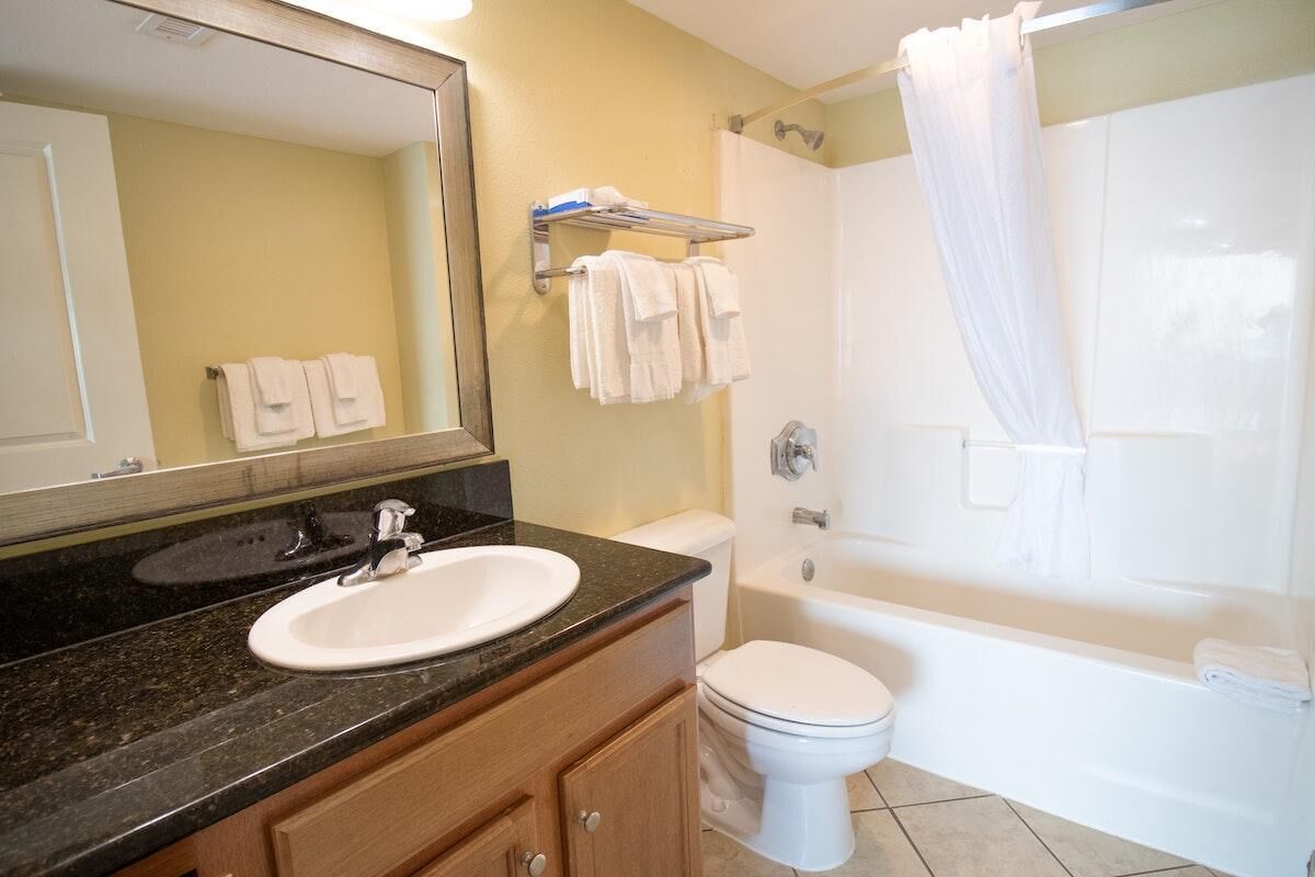 A bathroom with a sink, toilet, and bathtub.