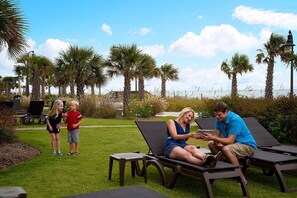 Relax in style with ocean views, lounge chairs, and a tranquil lawn.