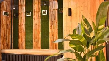 A wooden bench with a green wall in the background.