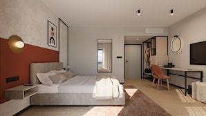 A modern bedroom with a bed, bedside table, and a desk with a chair.