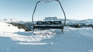 A ski lift chair with a sign reading #CHATEL, indicating a hotel or resort.