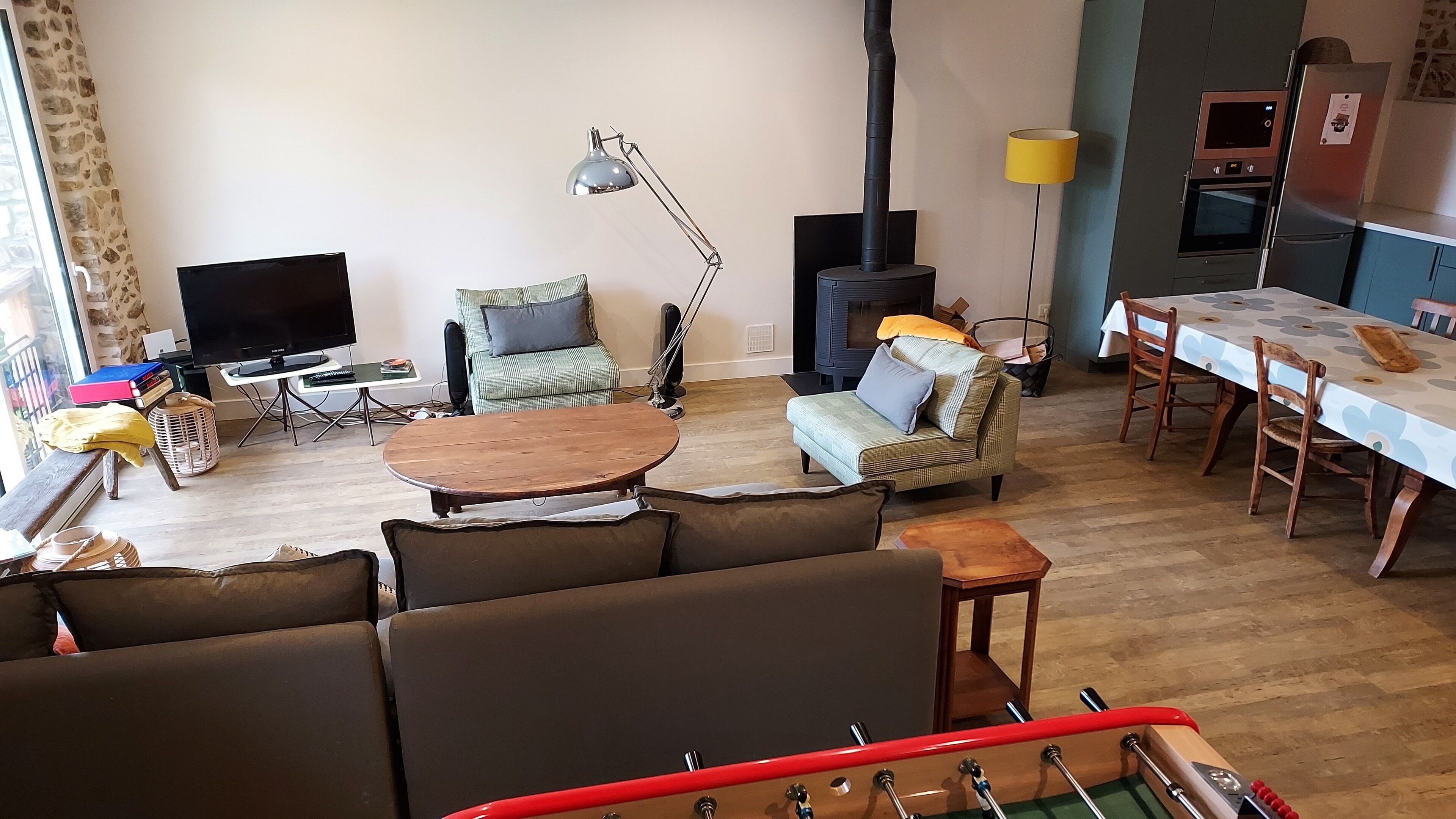A cozy living room with a sofa, a coffee table, a TV, and a fireplace.