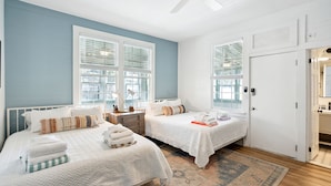A hotel room with two beds, a ceiling fan, and a large window with blinds. - Folliday Inn- The Aquarama- Room 33, Large Pool, 1 Pet w/fee (Folly Beach)