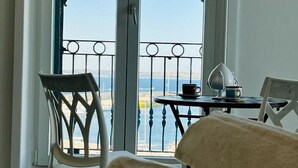 A balcony with a view of the sea, a table with a cup and saucer, and a chair. - Dimora San Felice - I limoni (Gallipoli)