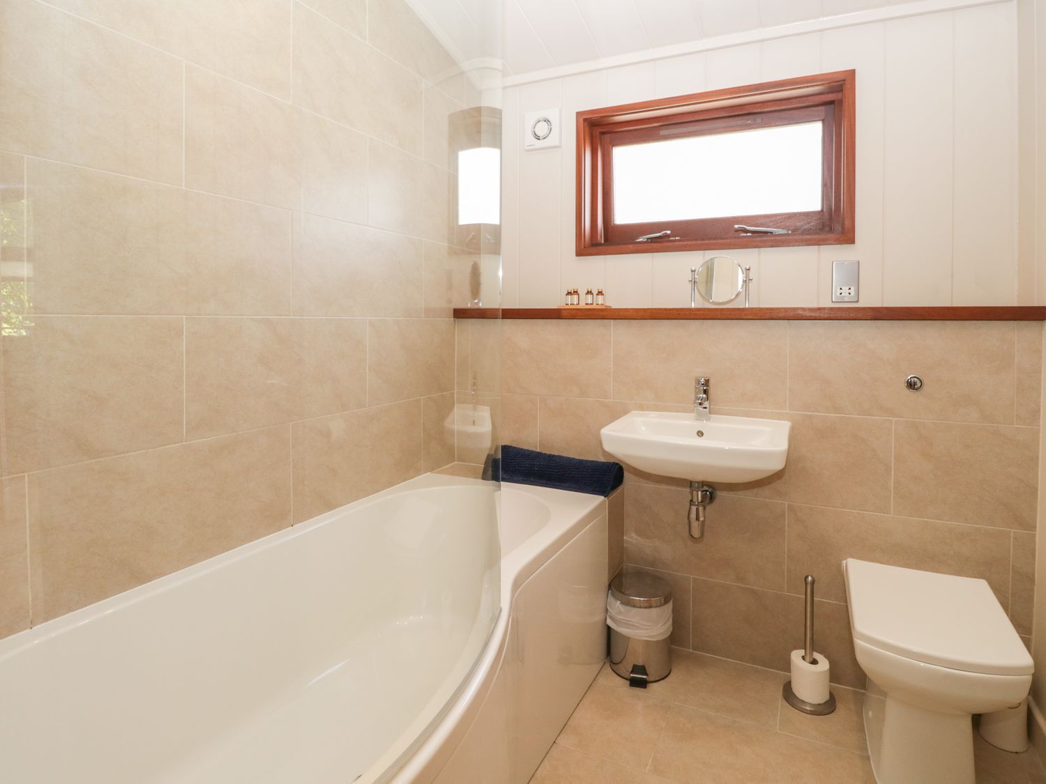 A bathroom with a bathtub, sink, and toilet.