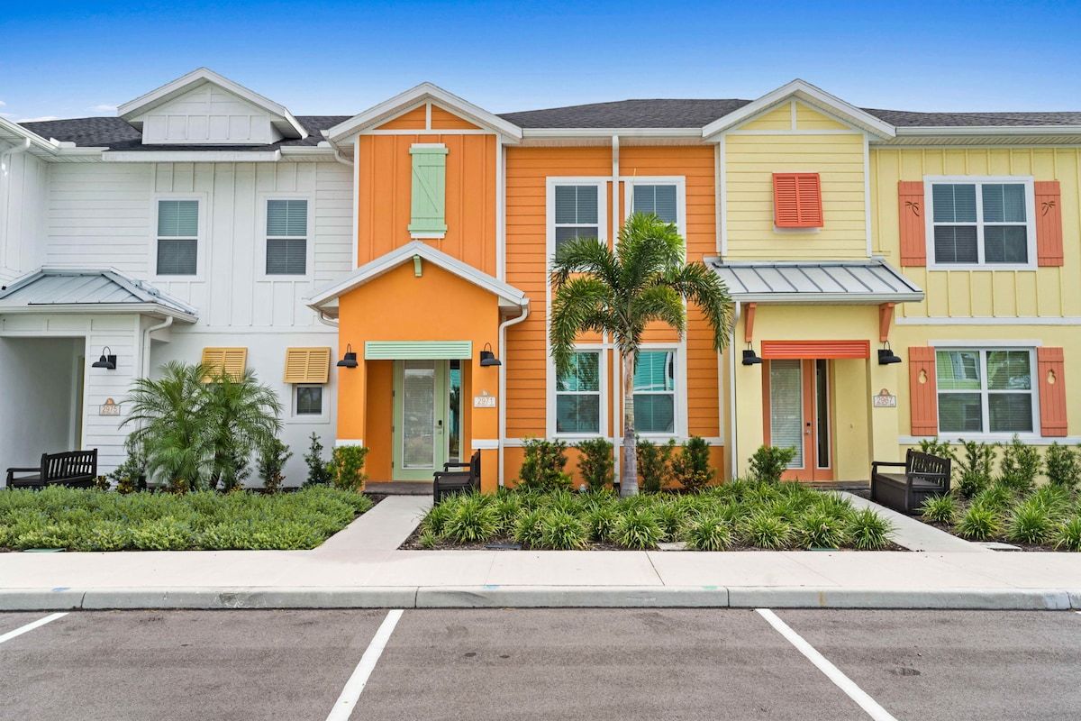 A playful blend of pastel and vibrant hues brings these Margaritaville inspired homes to life, framed by palms and greenery.