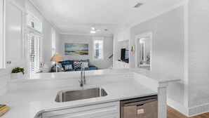 A modern kitchen with white cabinetry, a stainless steel sink, and a built-in dishwasher. - Renovated 30A Bungalow 5 Min Walk to Beach!! (Santa Rosa Beach)
