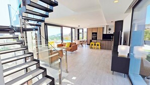 A modern interior with a staircase, a dining area, and a kitchen. - Benidorm sky - High-rise apartments (Benidorm)