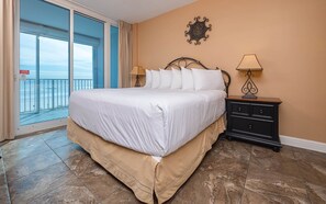 Enjoy ocean views from the large bed, featuring a comfortable bed skirt and crisp linens.