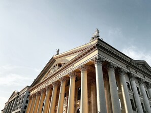 A grand building with classical architecture, featuring tall columns and detailed carvings.