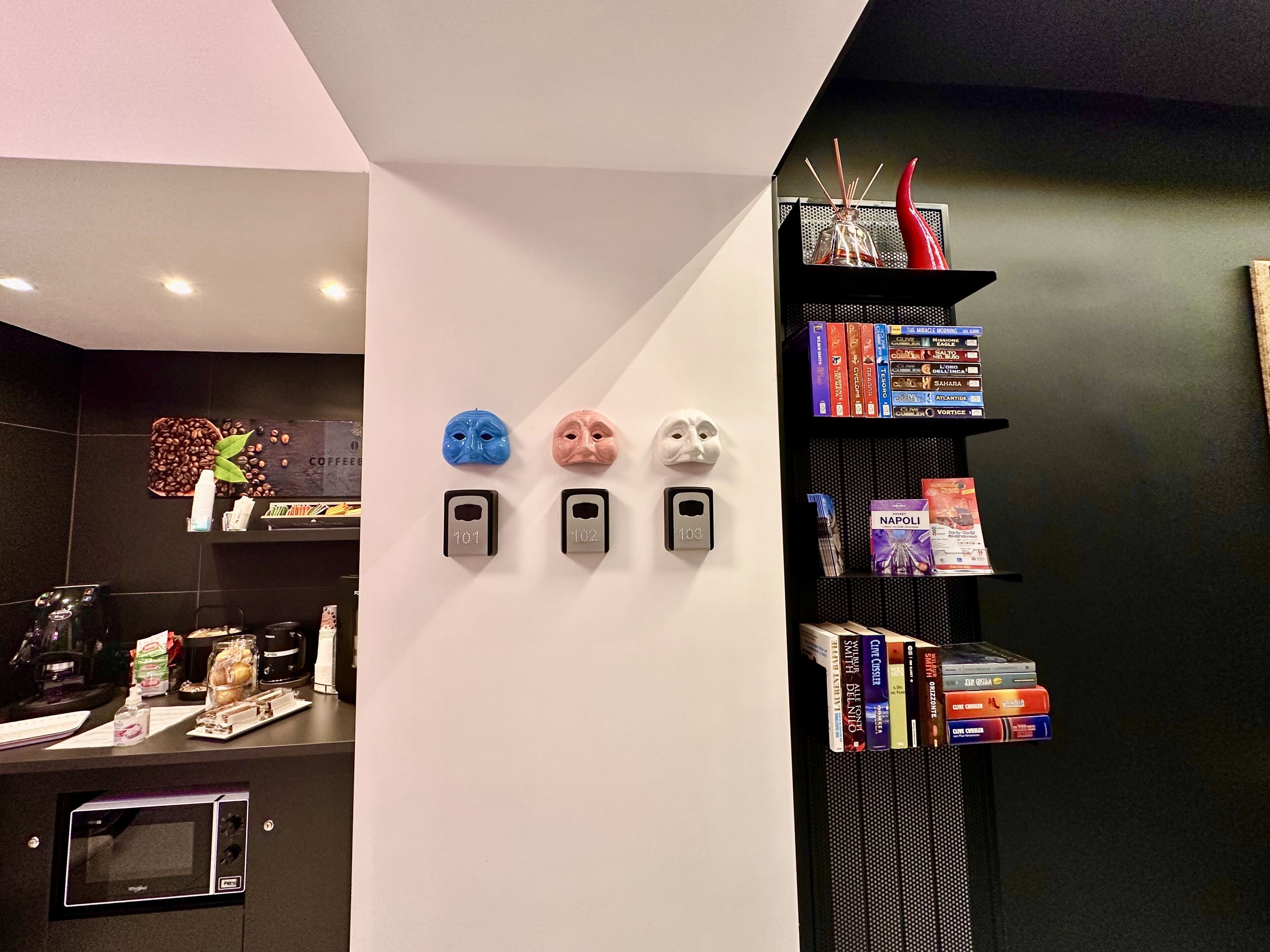 A modern kitchen with a coffee machine, a microwave, and a coffee bean display.