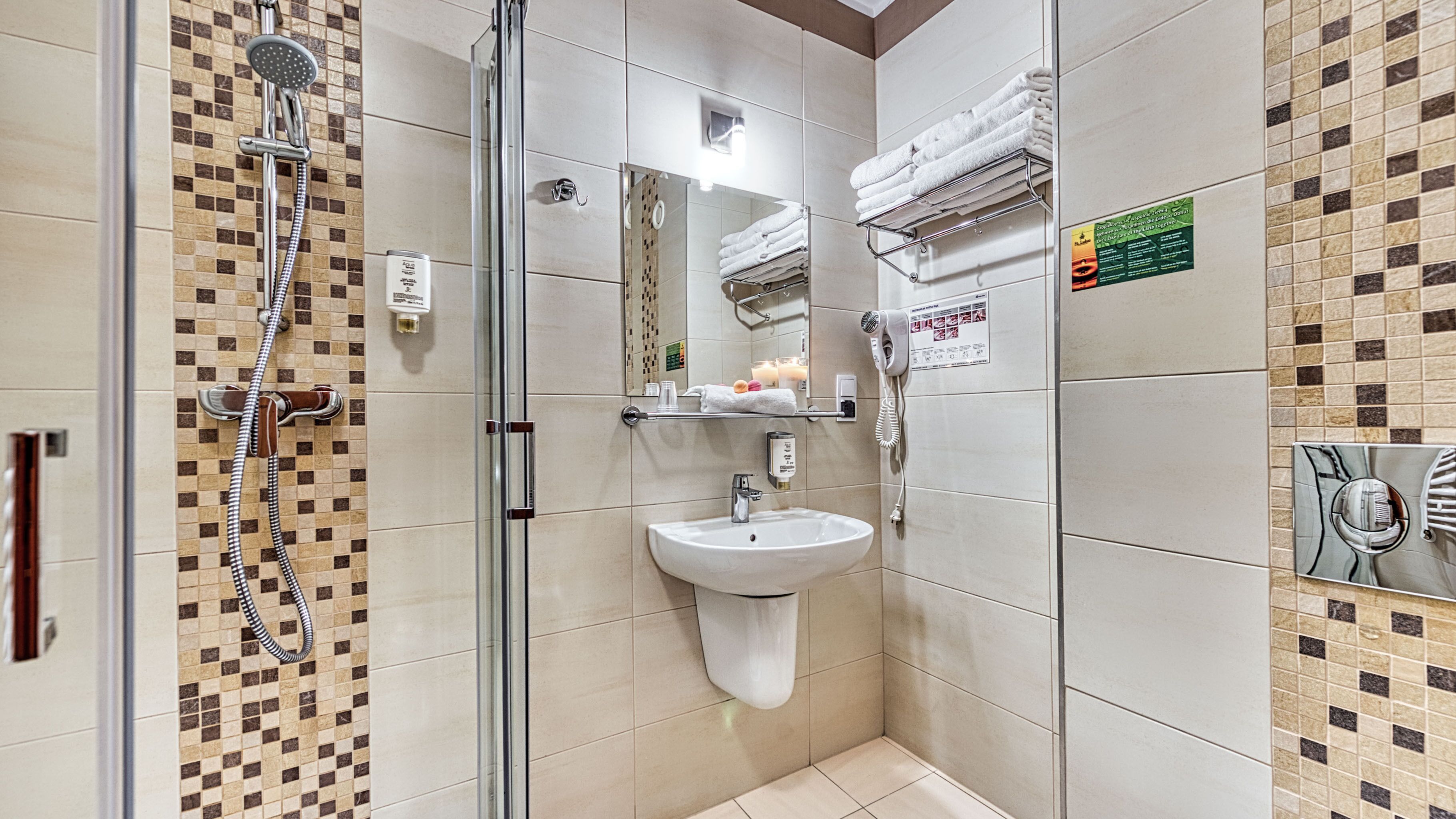 A modern bathroom with a glass shower enclosure, a sink, and a towel rack.