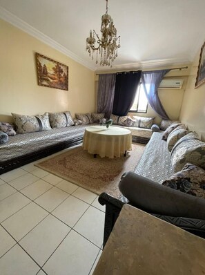 Relax in this stylish living room with a sofa set, coffee table, and large painting.