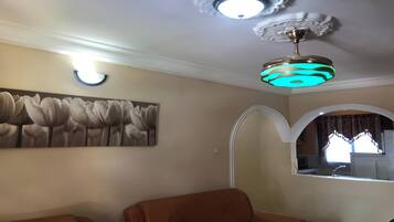 Luxury Apartment | Living area | 36-inch Smart TV with cable channels