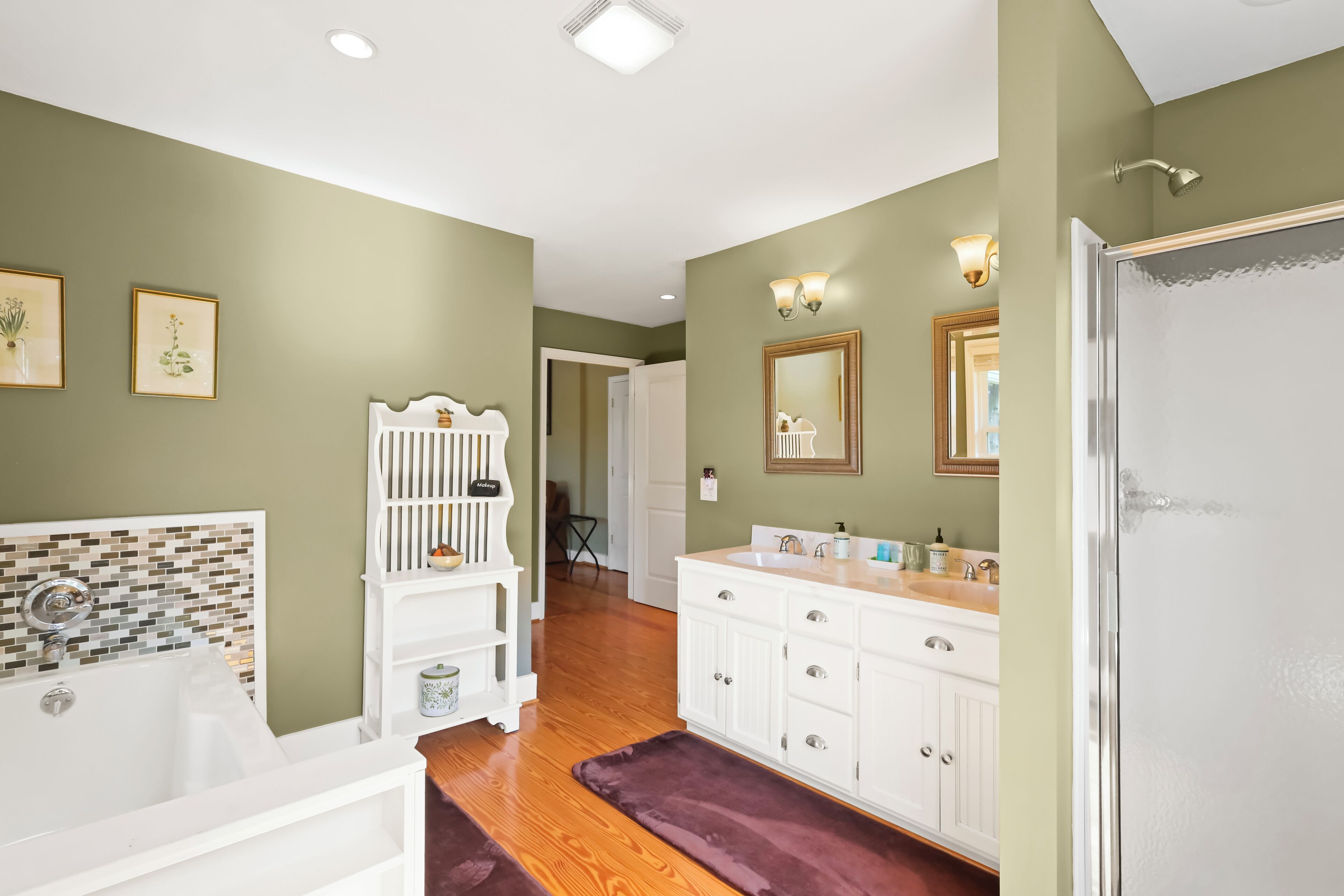 Master suite bathroom, featuring a tub, walk-in shower and double vanity.