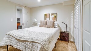 A bedroom with a bed, bedside table, lamp, and two wall-mounted picture frames. - 9 Mi to Dtwn Denver: Aurora Vacation Rental (Aurora)
