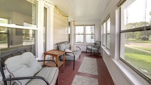 A covered porch with a sofa, chairs, and a small table. - Family-friendly Jackson Home w/ Sunroom: Near Golf (Jackson)