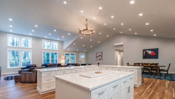 A spacious kitchen with a large island, white cabinetry, and a chandelier. - Brand New October 2023! Ultimate Golfers House in Bandon! Adjacent Sheep Ranch! (Bandon)