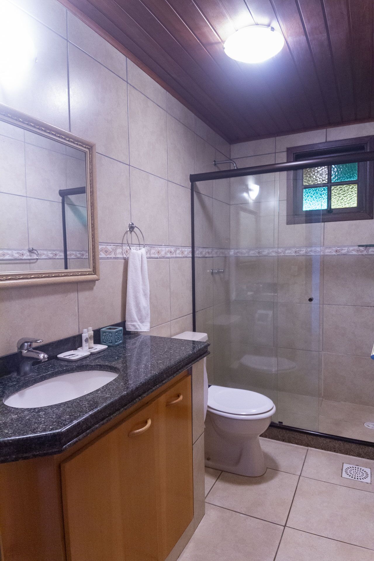 A bathroom with a sink, mirror, and toilet.