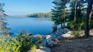 A stone staircase leading to a lake surrounded by trees.