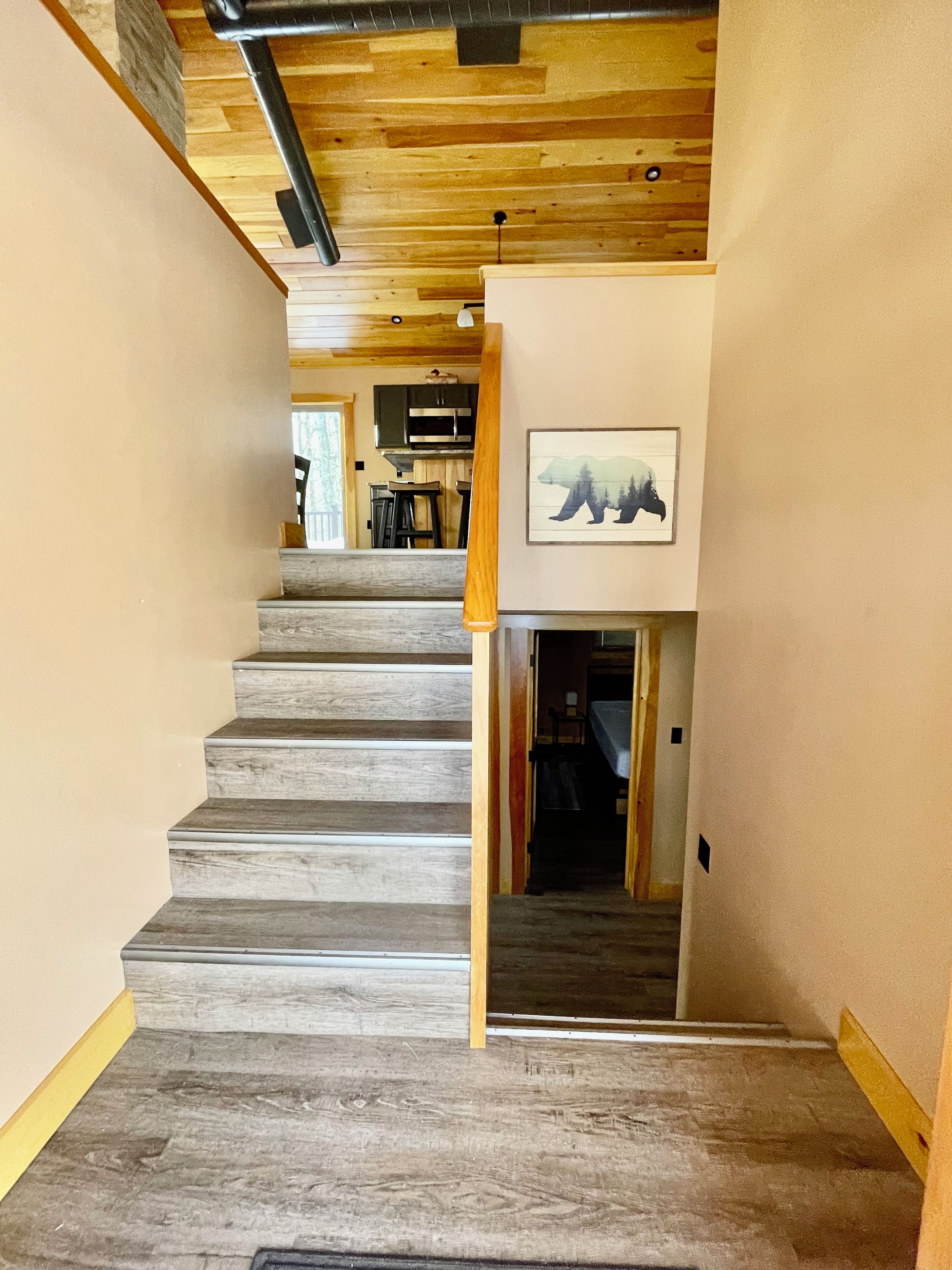 A staircase with wooden steps leading to a dining area.