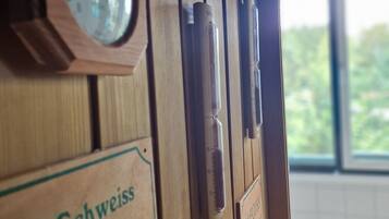 A wooden door with a clock and signs in German.