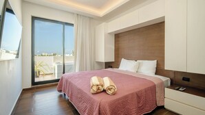 A hotel room with a large bed, a nightstand, a TV, and a view of the outdoors. - Modern apartment in the center near the beaches (Playa del Carmen)