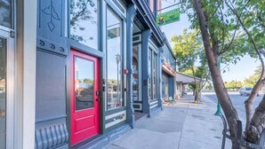 A storefront with a red door, large windows, and a sign for 'Pawsitive Nature Boutique'. - Historic Main Street Lofts - 3rd floor (Gunnison)