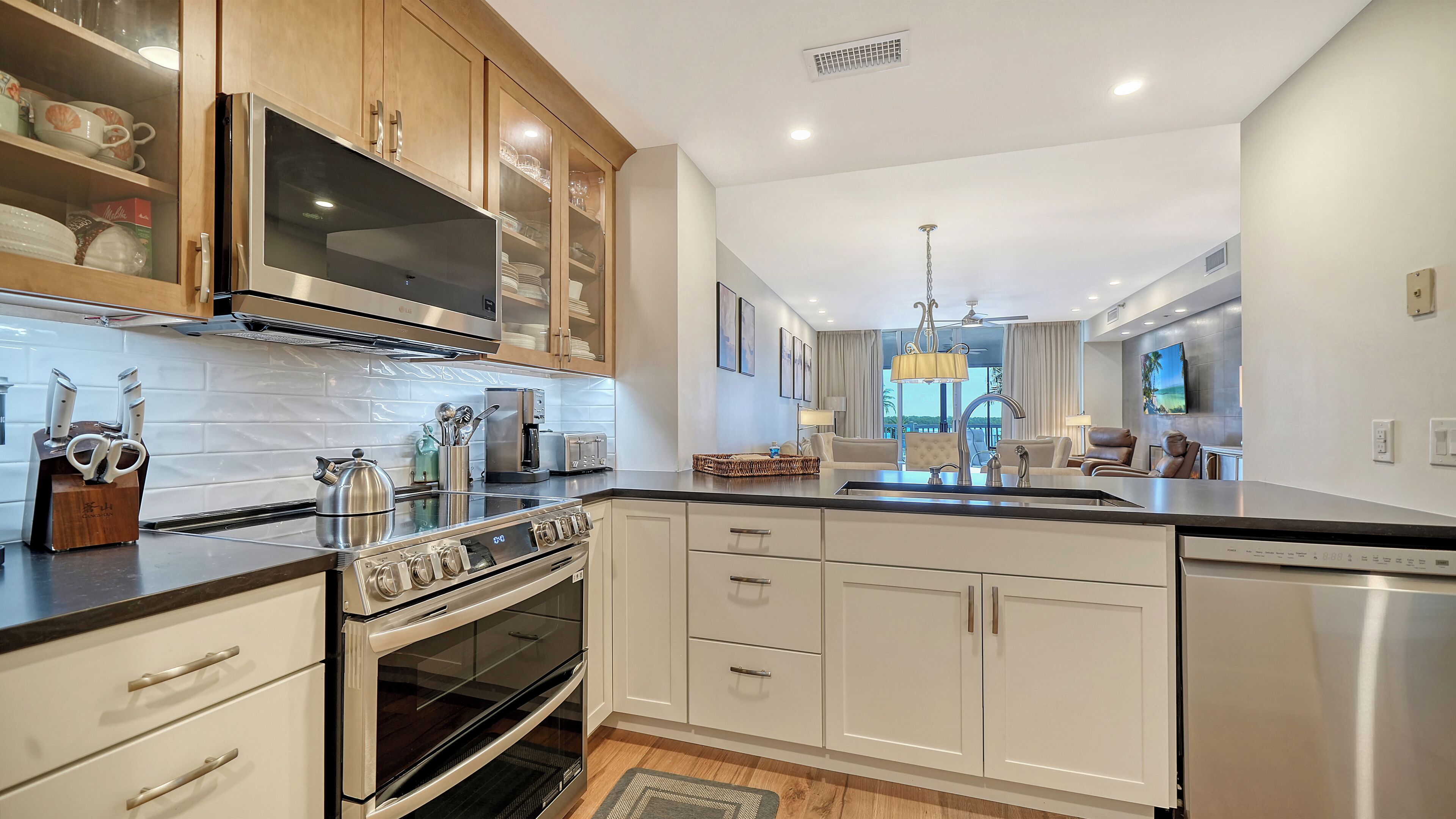 A modern kitchen with stainless steel appliances, wooden cabinets, and a central island.