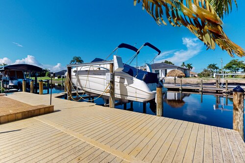 Canal-front home with private heated pool, dock, river views, patio, grill & W/D