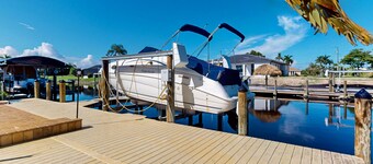 Canal-front home with private heated pool, dock, river views, patio, grill & W/D