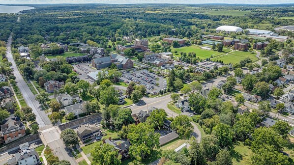 An aerial view of a campus with multiple buildings, parking lots, and green spaces. - Historical Home Close To Downtown (Geneva)