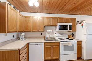 Fridge, microwave, oven, stovetop - Dog-friendly condo near beach with lake views, hot tub, sauna, pool, dock, grill (Whitefish)