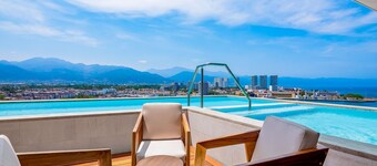 Resort condo with balcony, scenic view, rooftop pool, & well-equipped kitchen