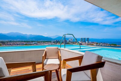 Resort condo with balcony, scenic view, rooftop pool, & well-equipped kitchen