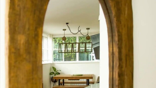 A kitchen with a wooden arch doorway, a white countertop, and a hanging light fixture. - 2 Double bedroom Apt in Central Bath with parking

 (Bath)