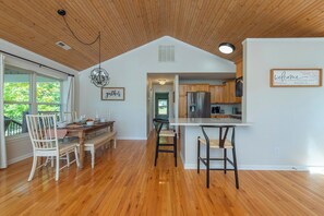 A spacious kitchen with wooden cabinets and a stainless steel refrigerator. - Mtn View, Fire Pit+Grill, WiFi! Nearby Town & AVL! (Burnsville)