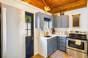 Fridge, microwave, oven, stovetop - Secluded lakefront home with dock, fire table, lake views, & streaming (Gravois Mills)