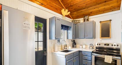 Secluded lakefront home with dock, fire table, lake views, & streaming