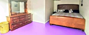 A bedroom with a wooden dresser, a bed with a patterned bedspread, and a purple carpet. - Atlanta/Stone Mountain, fenced yard, washer&dryer, Wi-Fi (Stone Mountain)