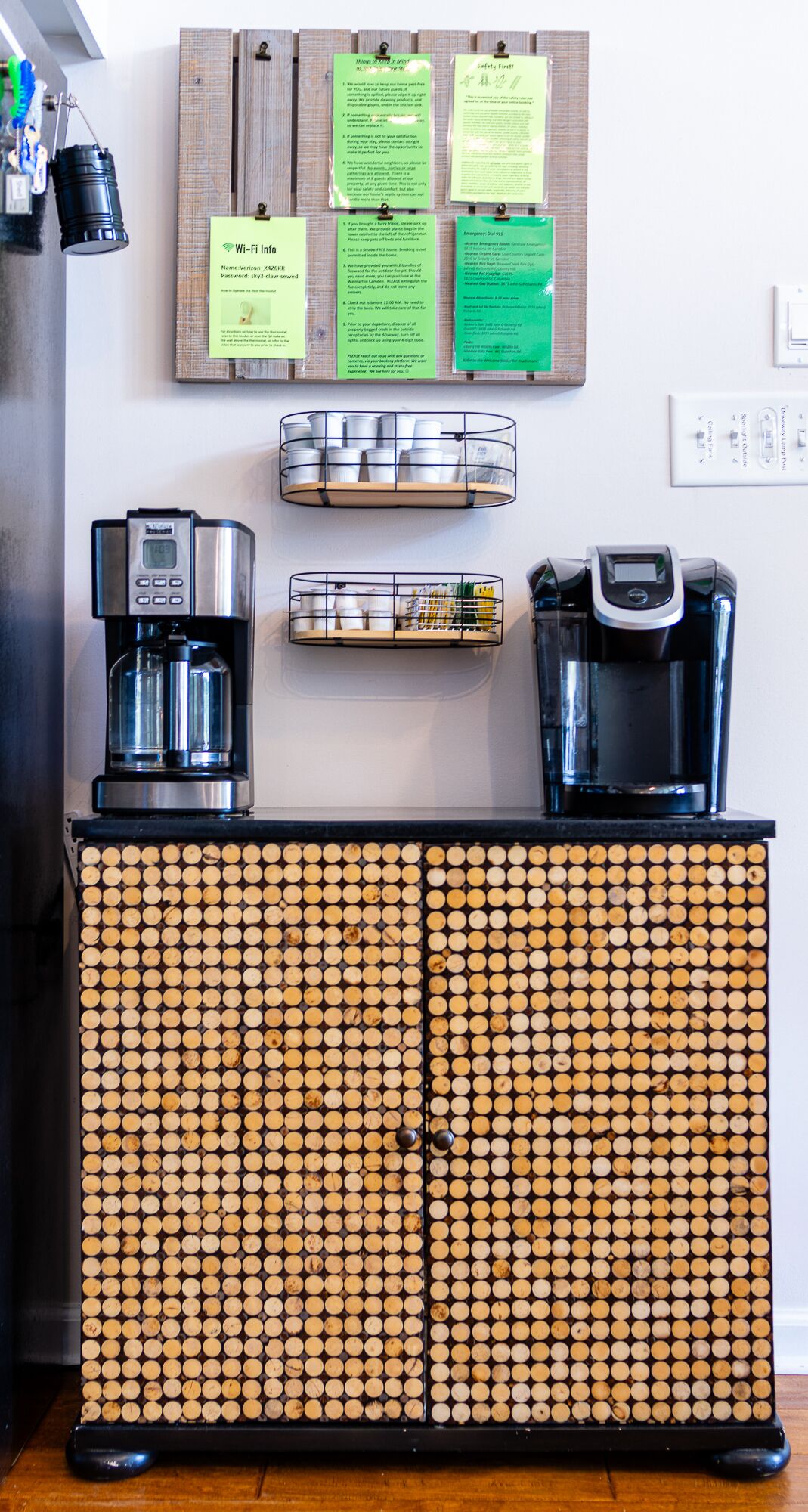 A coffee station with a coffee machine, a water dispenser, and a basket of coffee pods.