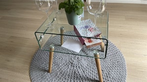 A glass table with wine glasses, a potted plant, and a card on a knitted rug. - On a golf estate with Mountain views.
4km from the Beach (Cape Town)