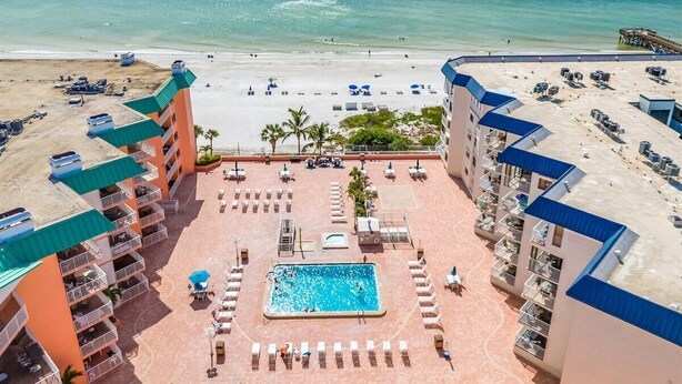 A resort with a pool, beach, and ocean view.